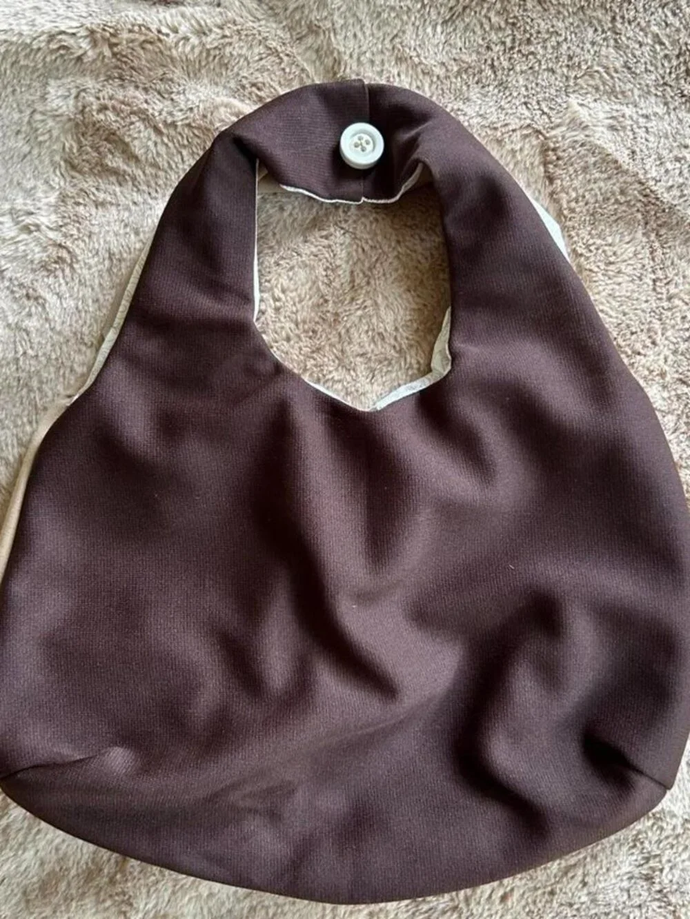 Brown & tan hobo bag with red ant pattern front pocket and hand sewn buttons